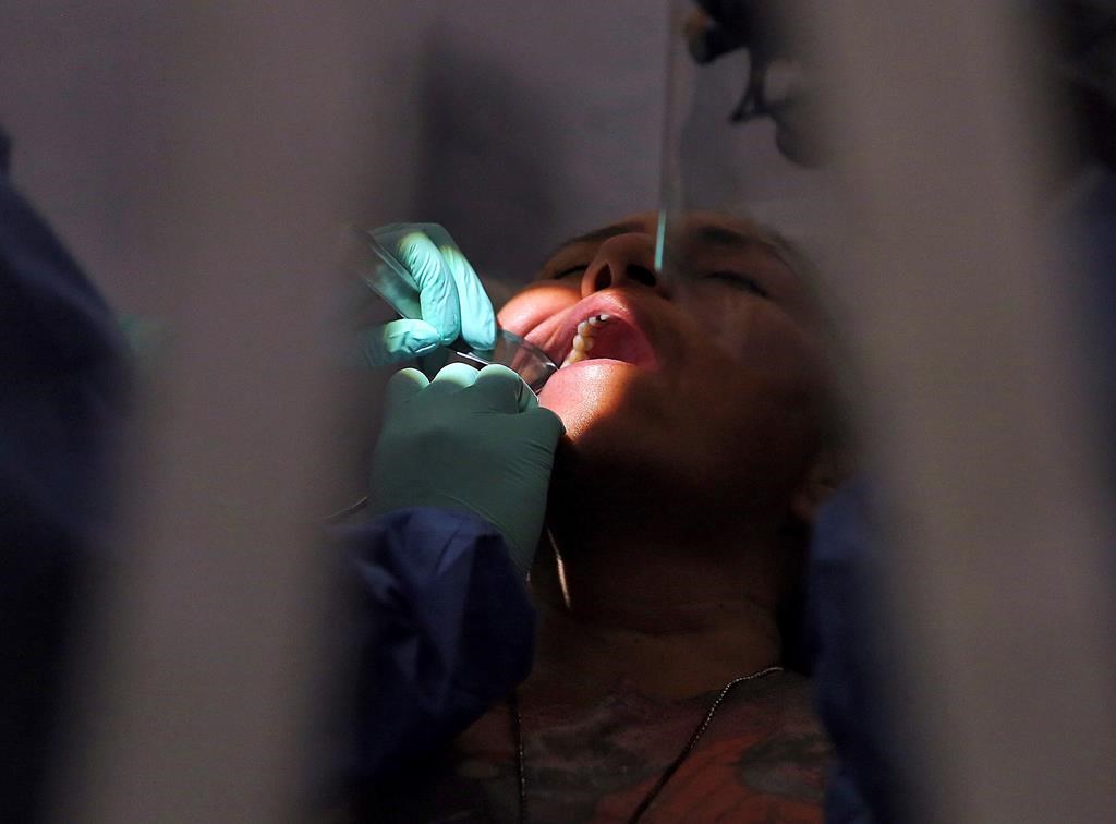 FILE photo. - The federal housing and dental benefits rolled out last year have had 'atrocious' take-up, a new report says, with hundreds of thousands of Canadians potentially missing out on the benefits. THE CANADIAN PRESS/AP-Joel Martinez/The Monitor via AP.