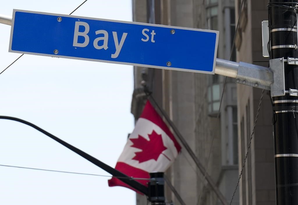 The Bay Street financial district is shown with a Canadian flag in Toronto on Friday, August 5, 2022. THE CANADIAN PRESS/Nathan Denette.