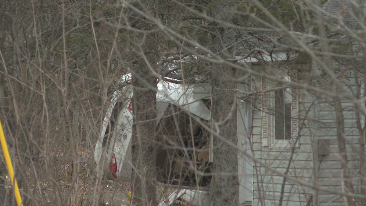 The car could be seen lying on its side outside the house Wednesday morning.
