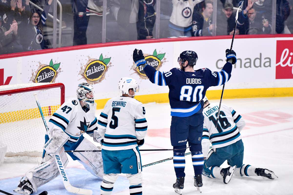 Winnipeg Jets’ Pierre-Luc Dubois (80) celebrates his goal against San Jose Sharks goaltender James Reimer (47) during first-period NHL action in Winnipeg on April 10.