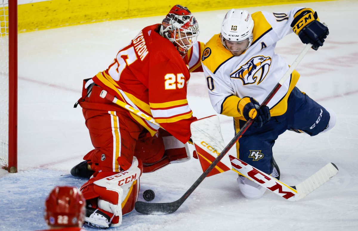 Nashville Predators forward Colton Sissons, right, tries to get the puck past Calgary Flames goalie Jacob Markstrom during second period NHL hockey action in Calgary, Monday, April 10, 2023.
