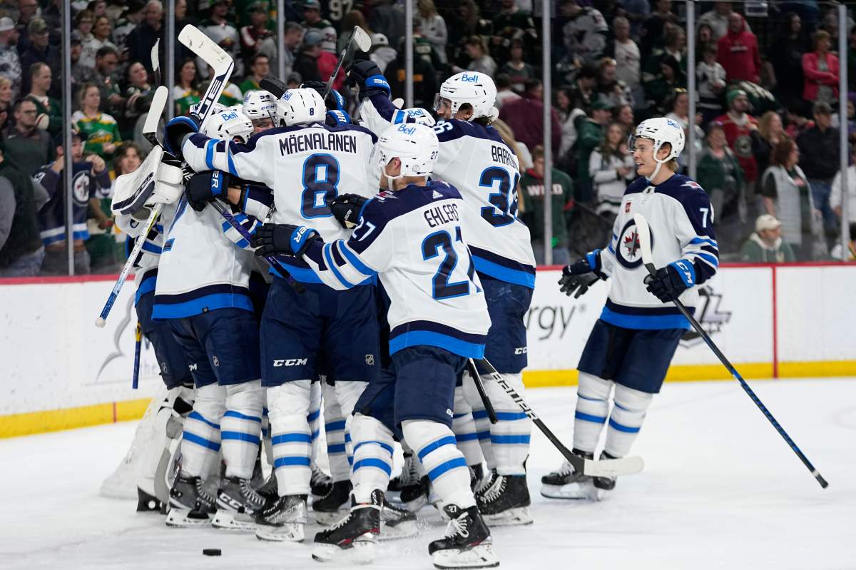 FILE - Winnipeg Jets players celebrate after a 3-1 win against the Minnesota Wild on April 11, 2023, in St. Paul, Minn.
