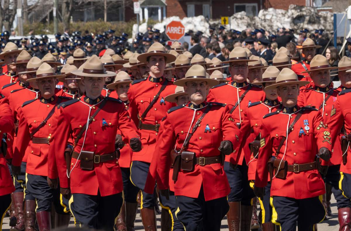RCMP officers and police officers from across Canada and the U.S. arrive for funeral services for Quebec provincial police Sgt. Maureen Breau in Trois-Rivieres, Que., on Thursday.
