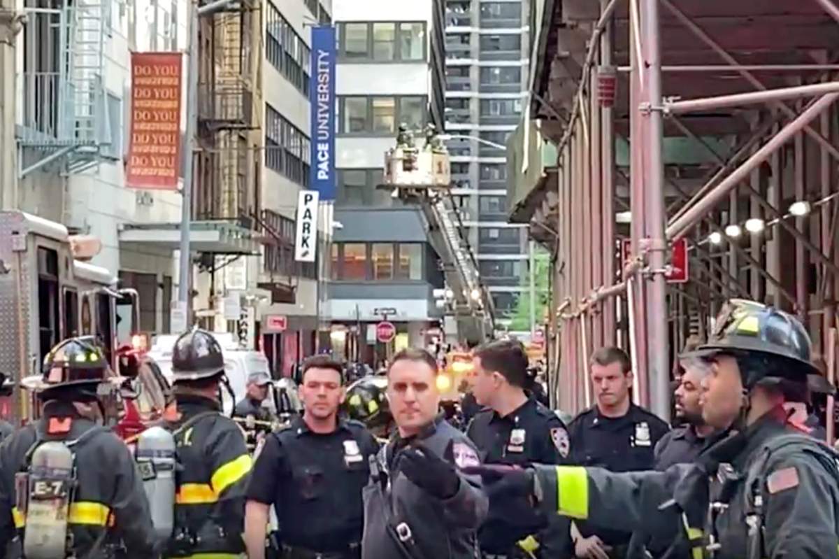 In this image taken from video, New York City Police and Fire Department personnel cordon off an area in New York’s Financial District, Tuesday, April 18, 2023, near the site of a partially collapsed parking garage. It wasn’t immediately clear whether anyone was injured. (AP Photo/Ted Shafrey)