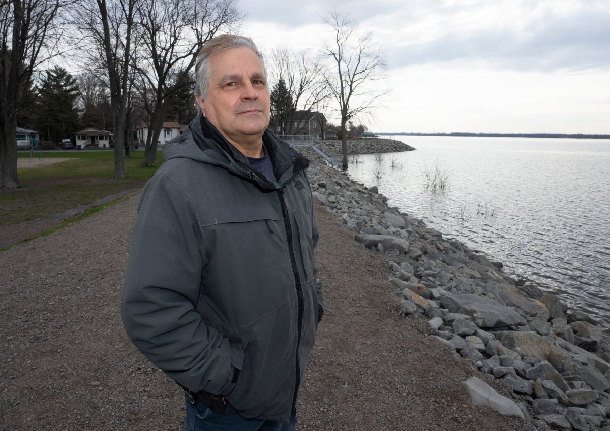 Richard Lauzon stands on the dike on the shore of Lake of Two Mountains, Wednesday, April 26, 2023 in Ste-Marthe-sur-le-Lac, Que. Lauzon is leading the ongoing class action lawsuit over the 2019 Ste-Marthe-sur-le-Lac dike breach. 