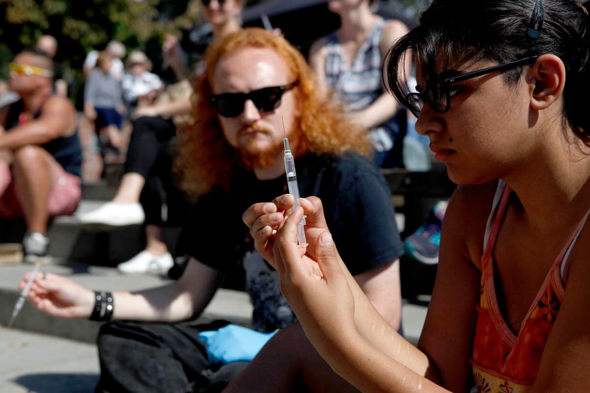 Alex Delongchamp and Gurman Tatla take part in a mass group naloxone training seminar during International Overdose Awareness Day at Centennial Square in Victoria, B.C., on Sat. August 31, 2019.