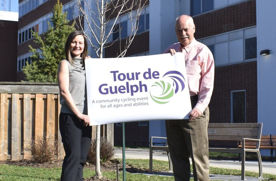Elizabeth Stewart and Clarence Haverson display the new Tour de Guelph logo.