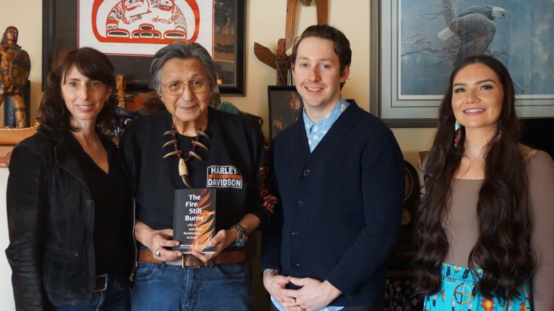 Elder Sam George stands with three of four co-authors on his new memoir, The Fire Still Burns, on Thurs. April 20, 2023. Pictured are (left to right) Langara College instructor Jill Yonit Goldberg and students Dylan MacPhee and Tanis Wilson.