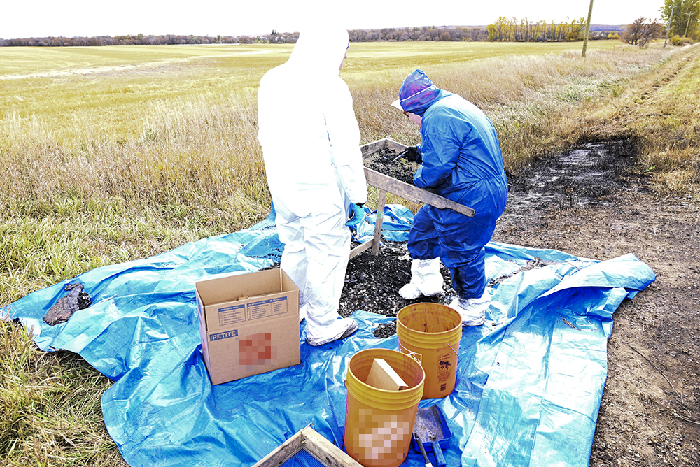 Forensic investigators look into the crime scene in April.