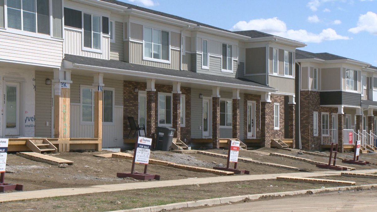 A row of houses for sale. CMHC is forecasting continued slow growth in housing after releasing their outlook report on Apr. 27.