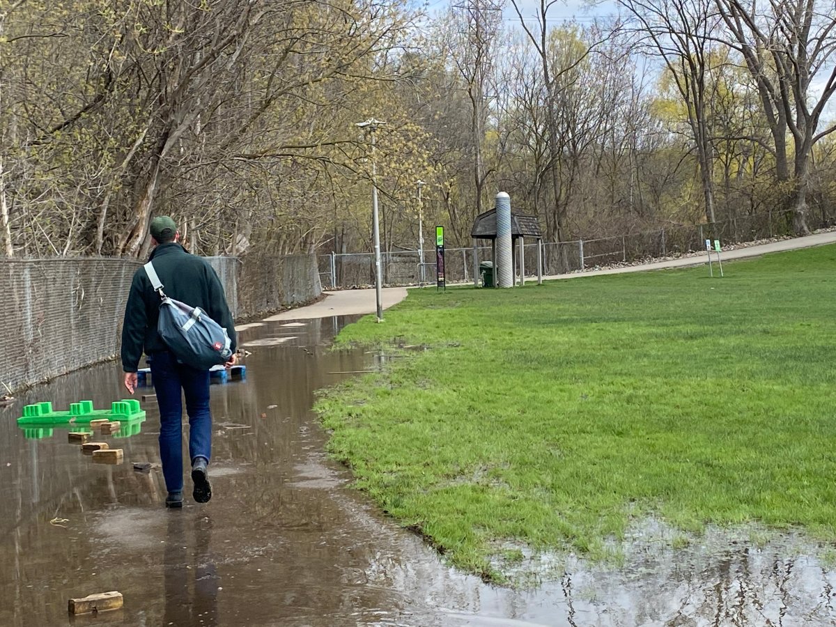 Pooling water caused by an overflowing pond is making for a wet, muddy walk in Riverdale Park West.
