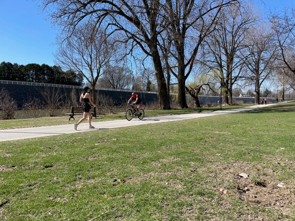 A runner and cyclist out on the trail at Harris Park on April 13, 2023.