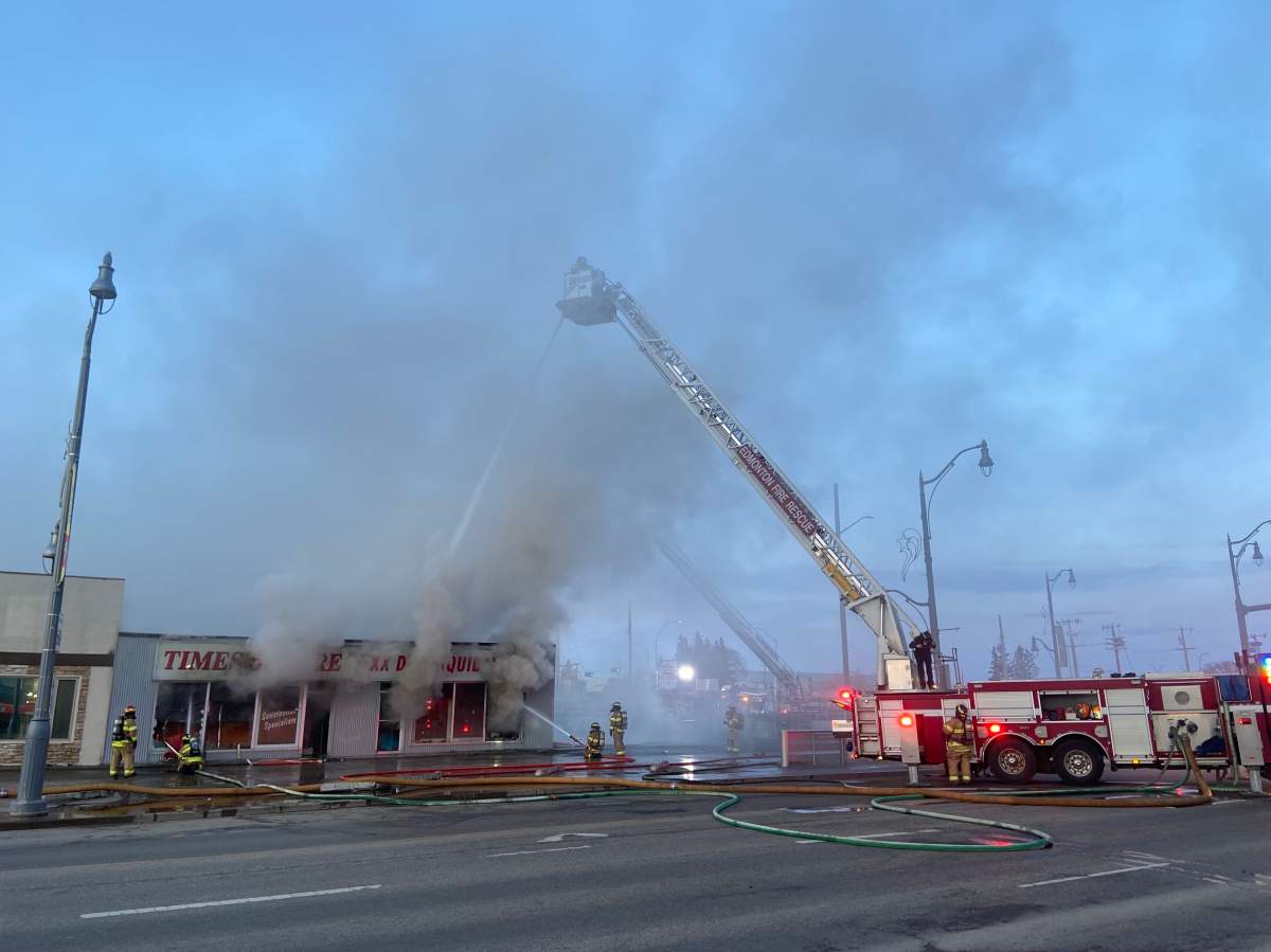 Fire burns at a commercial building on Stony Plain Road and 156 Street in Edmonton on Friday.