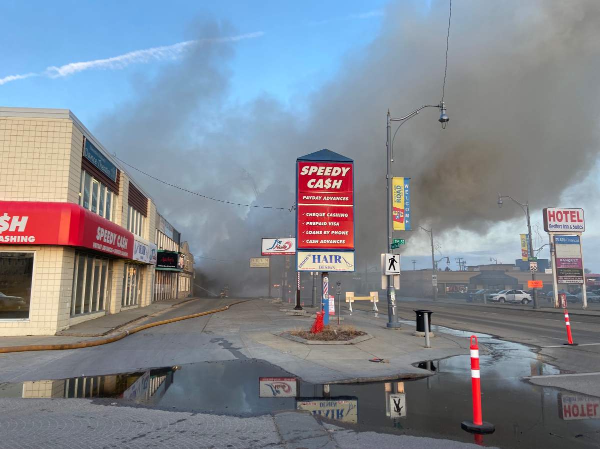 Fire burns at commercial building on Stony Plain Road and 156 Street in Edmonton on Friday, April 14, 2023.