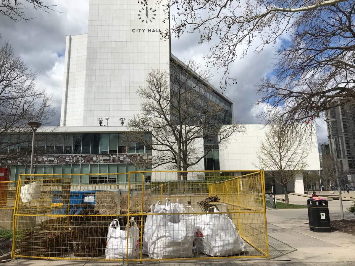Contractors set up a staging area between Hamilton City Hall and the former Canadian Football Hall of Fame. The city will be installing removable security bollards in three phases during the spring of 2023.