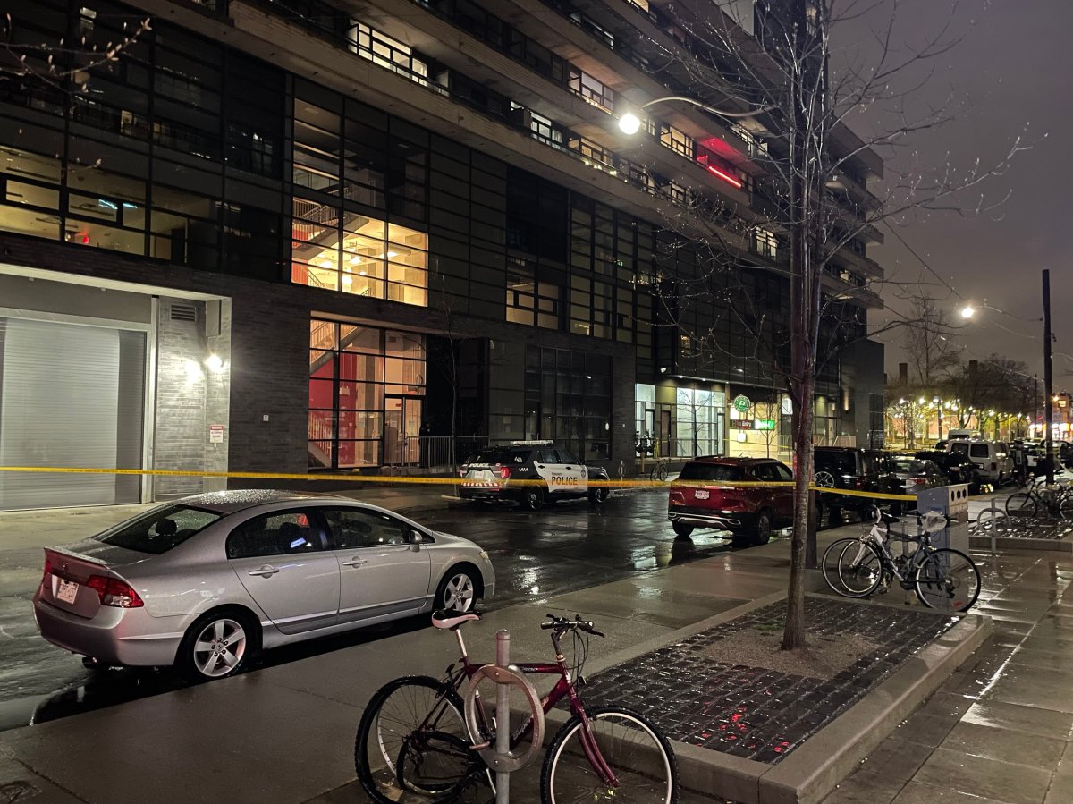 Police put up yellow tape after a fight near Queen and Lisgar streets on April 16, 2023.