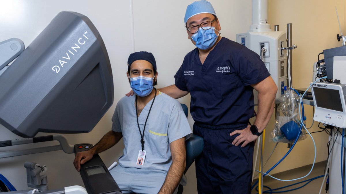 Dr. Eddie Matsumoto, urologist, robotic surgeon with St. Joe's Healthecare Hamilton working with resident physician in training Dr. Hark Randhawa. A education program around since 2017 is working on accelerating the skills of first year residents to make them as more comfortable with every day procedures.