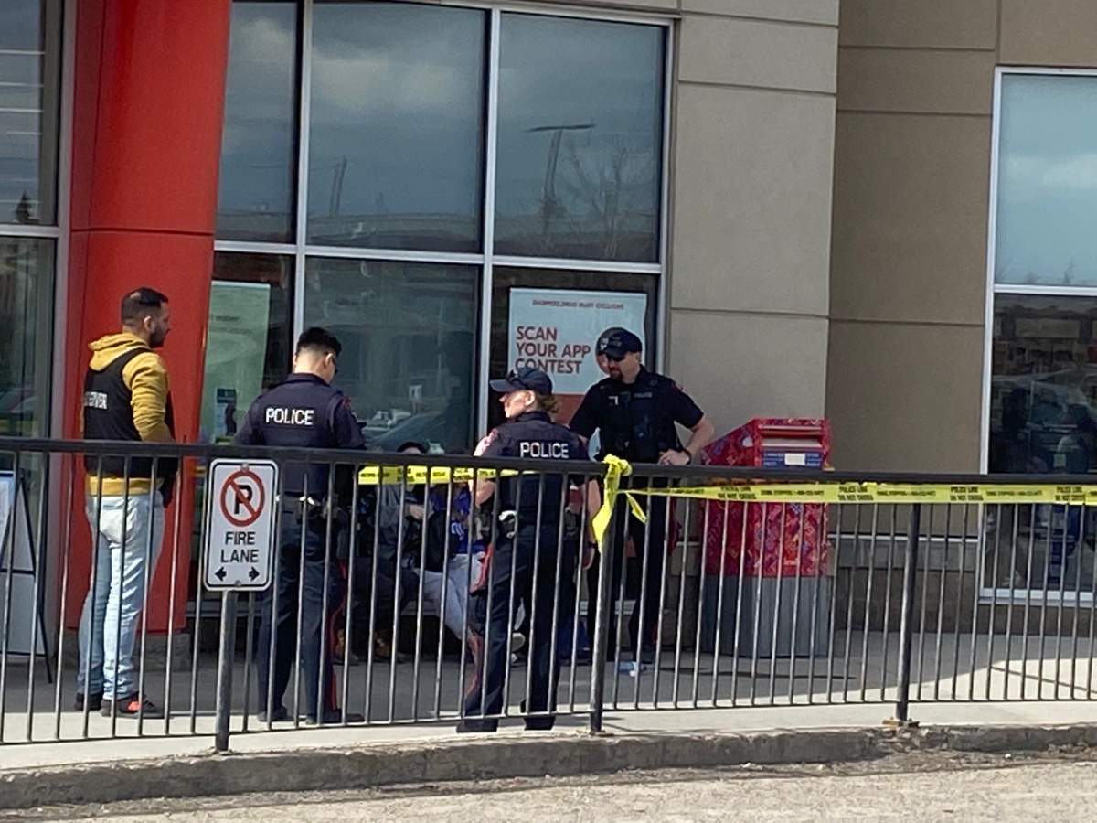 Police are seen outside Sunridge Mall with police tape, pictured on April 14, 2023.