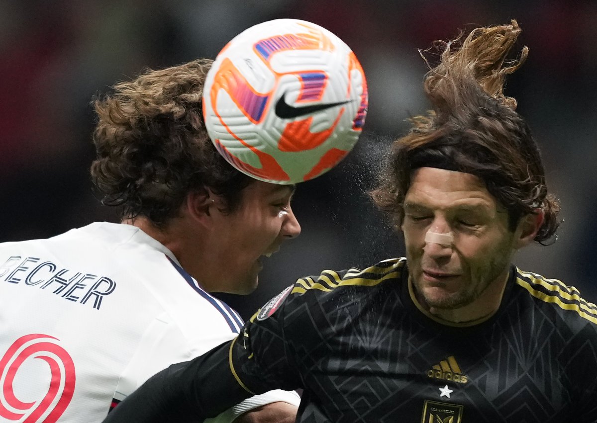 Simon Becher of the Vancouver Whitecaps, left, and Ilie Sanchez of Los Angeles FC vie for the ball during second-half CONCACAF Champions League action in Vancouver, on Wednesday, April 5, 2023. Los Angeles won 3-0.