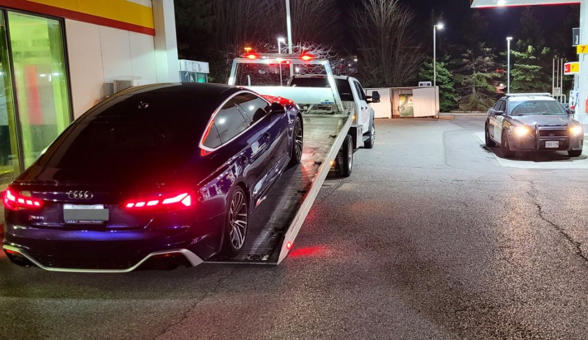 A car being towed after reportedly clocking double the speed limit on Highway 401 in Toronto in a tweet posted on April 9, 2023.