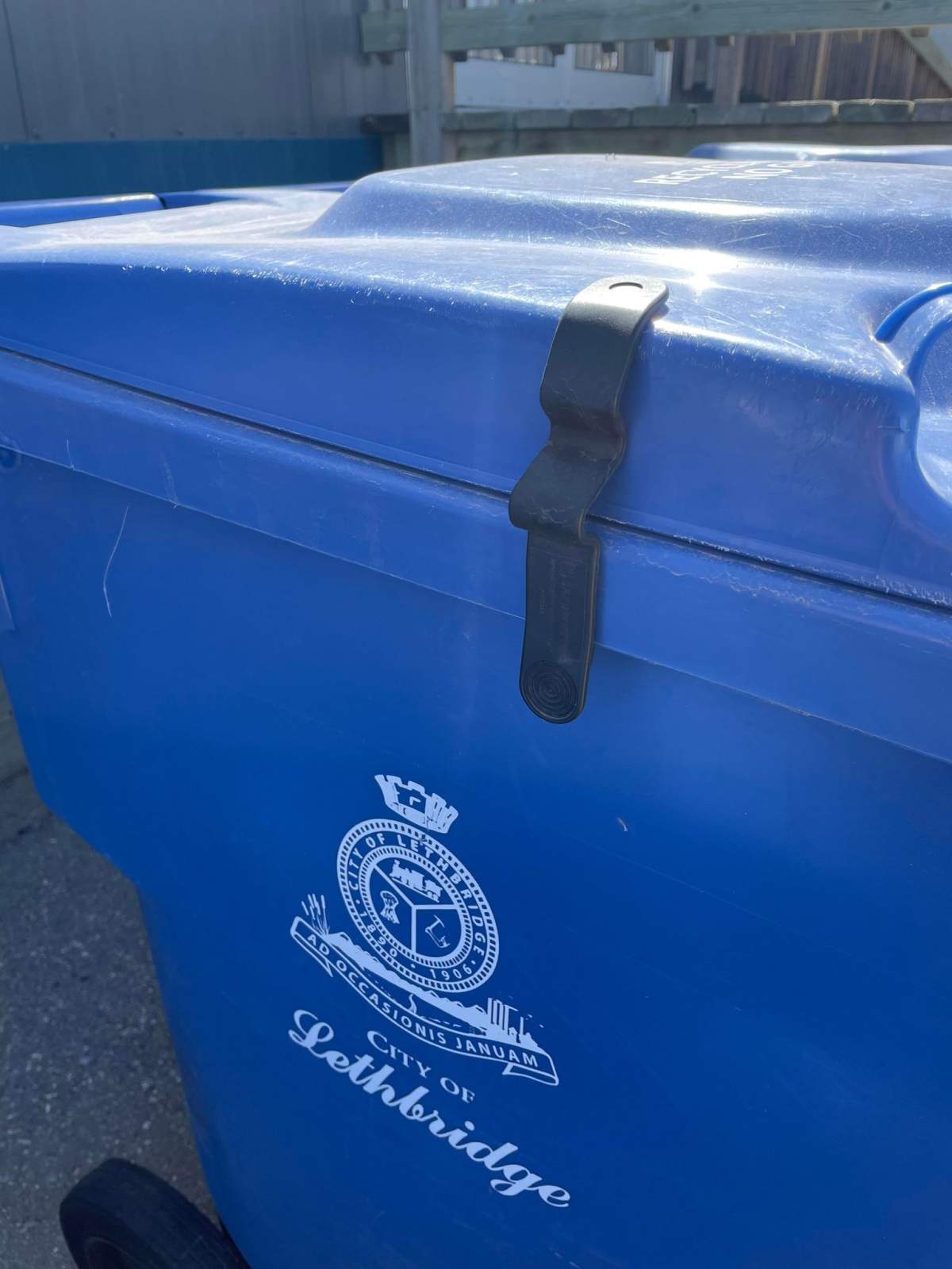 An example of a black latch used on a recycling bin in Lethbridge.