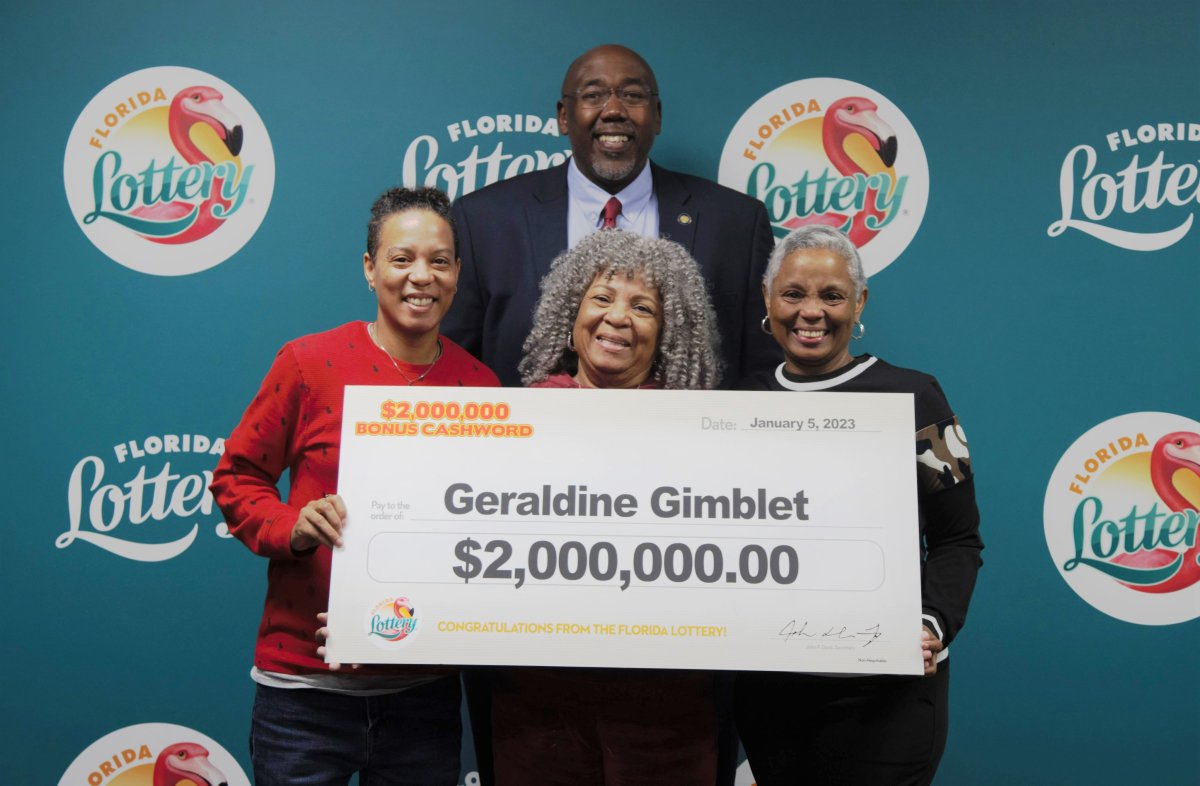 Geraldine Gimblet holding a giant cheque for US$2 million after she purchased a winning scratch off lottery ticket the day after her daughter finished cancer treatment.