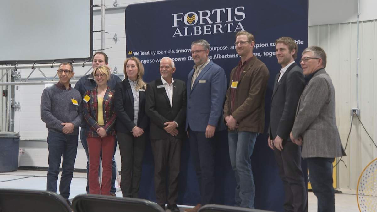 Officials pose for a photograph inside FortisAlberta’s new Coaldale facility, which opened in Feb., 2023.