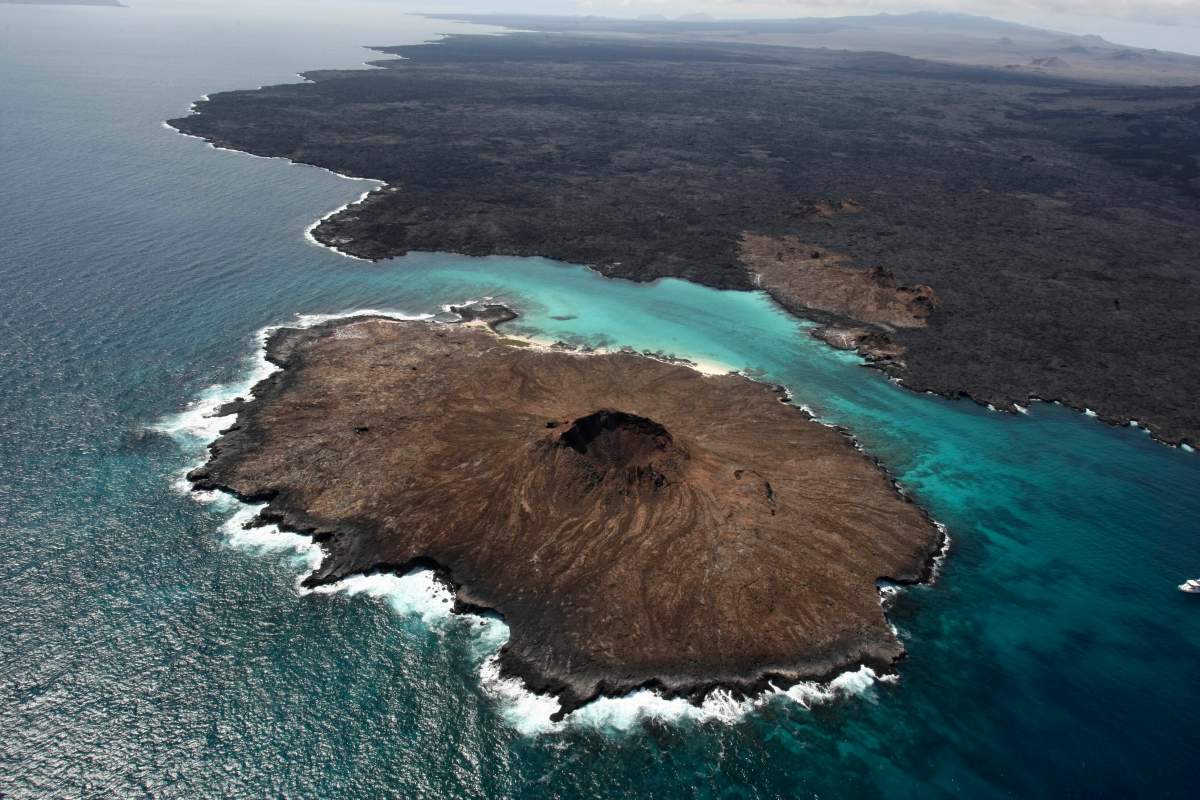 An aerial view of islands forming part of the Galapagos Marine Reserve amid turquoise waters.