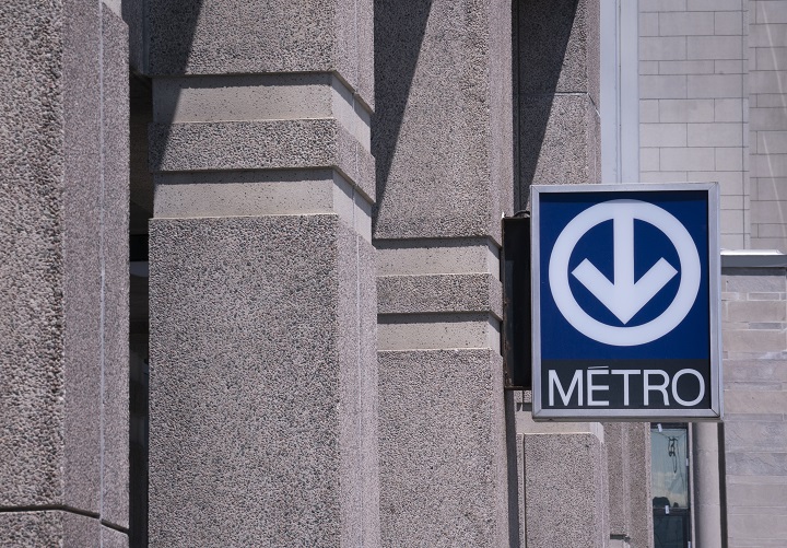 A direction sign to the subway, locally called the "metro", is seen in Montreal on June 18, 2019. 