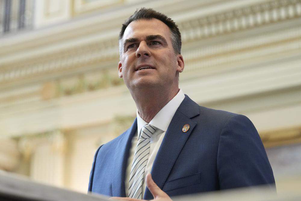 FILE - Oklahoma Gov. Kevin Stitt delivers his State of the State address on Feb. 6, 2023, in Oklahoma City. Stitt called for the resignations of several county officials on Sunday, April 16, in far southeast Oklahoma after the local newspaper released an audio recording of some of them discussing killing local journalists and hanging Black people.