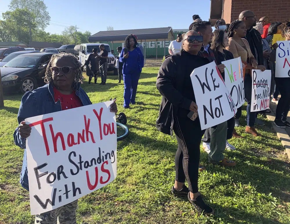 Glenda Austin of Idabel, Okla., holds a sign with other protesters, Monday, April 17, 2023, outside the McCurtain County Commissioners meeting room in Idabel, Okla.