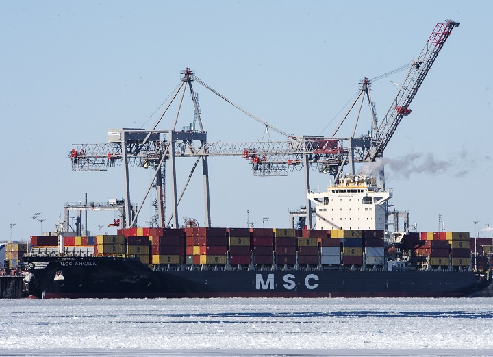 A container ship is docked in the Port of Montreal, Wednesday, February 17, 2021 in Montreal. Transport Minister Omar Alghabra says the federal government is committed to supporting the Port of Montreal as it seeks more funding for the ballooning cost of a container terminal expansion. 