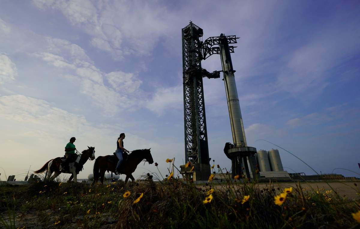 NASA Astronaut Sunita Williams, left, and Haley Esparza, right, ride horseback as they visit SpaceX’s Starship, the world’s biggest and most powerful rocket, as it is readied for launch at Starbase in Boca Chica, Texas, Wednesday, April 19, 2023. (AP Photo/Eric Gay)
