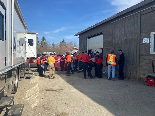 Parkland County fire crews going over their plan Monday, May 1, 2023, at Trestle Creek golf course where their command centre is.