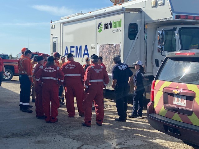 Parkland County fire crews going over their plan Monday, May 1, 2023, at Trestle Creek golf course where their command centre is.