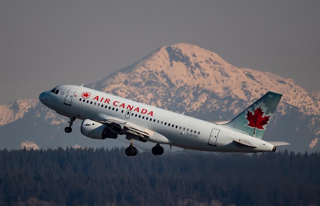 An Air Canada flight departing for Calgary takes off at Vancouver International Airport, in Richmond, B.C., on Friday, March 20, 2020. 
