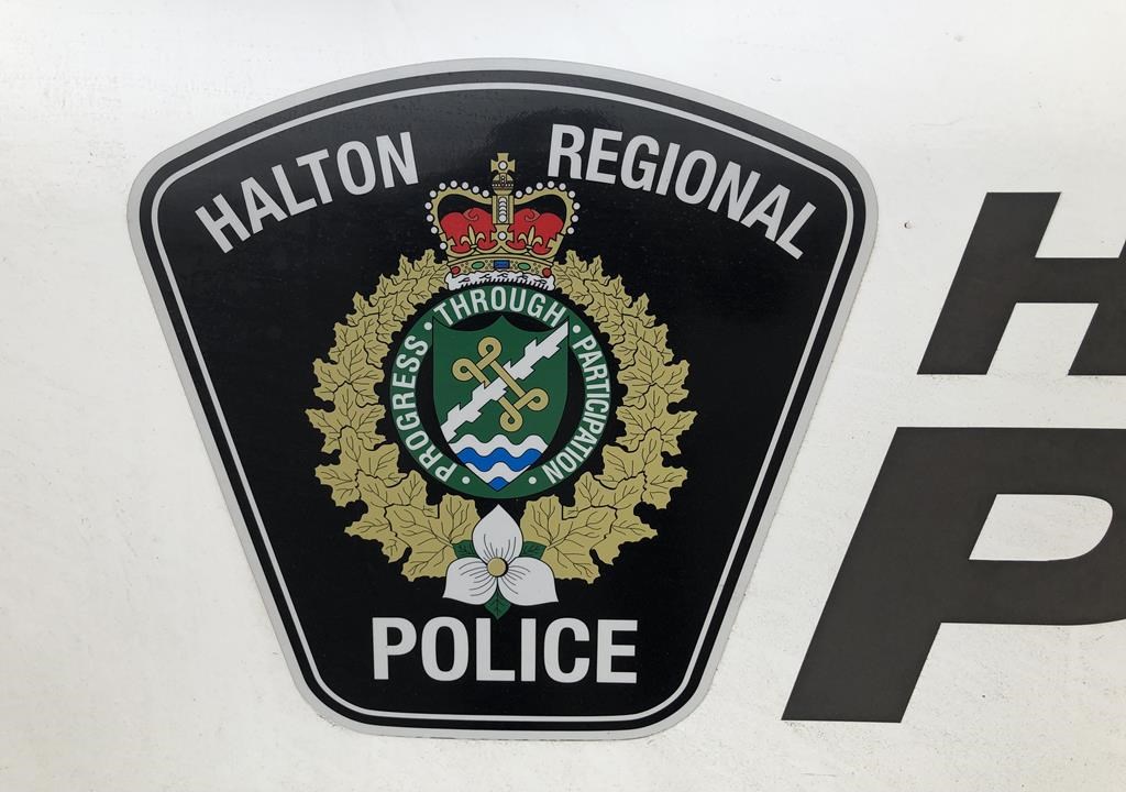 A Halton Regional Police logo is shown on a vehicle in Oakville, Ont., Wednesday, Jan.18, 2023. An eight-year-old girl is dead and a 21-year-old man is facing charges after a hit and run outside a school in Burlington, Ont. THE CANADIAN PRESS/Richard Buchan.