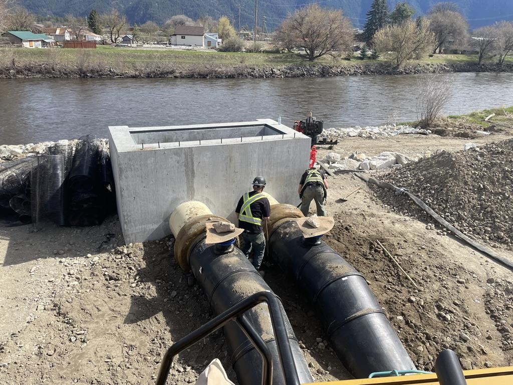 Employees in Grand Forks, B.C., work on a pumping system installed after the community was devastated by flooding in 2018. The B.C. River Forecast Centre says the risk of flooding near Grand Forks has been downgraded from a warning to an advisory.  