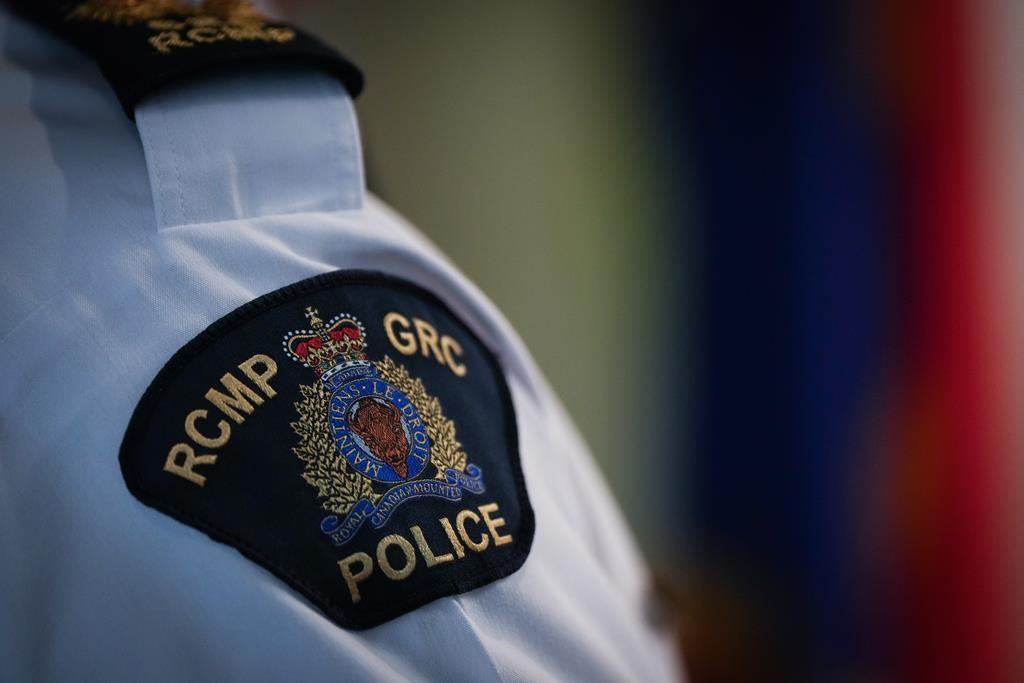 An RCMP patch is seen during a news conferencein Surrey, B.C., on Friday, April 28, 2023. Police in Maple Ridge, B.C., say they've arrested a pair of suspects after a 55-year-old man was found dead in the city on March 4.