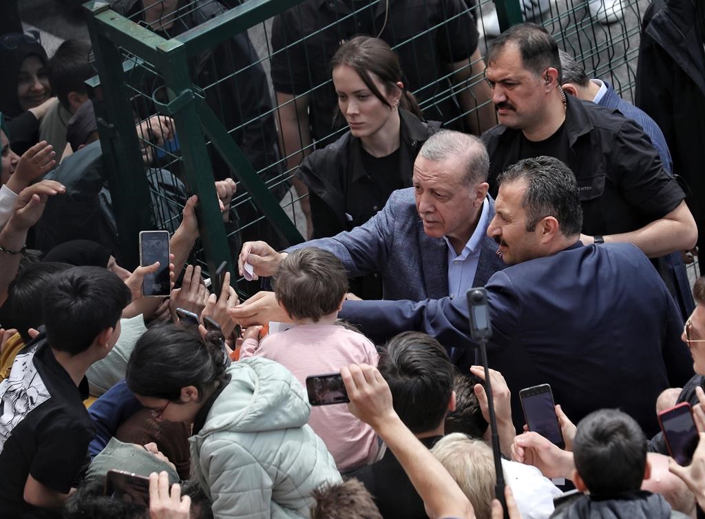 Turkey’s President Recep Tayyip Erdogan with supporters at a polling station, in Istanbul, Turkey, Sunday, May 14, 2023.