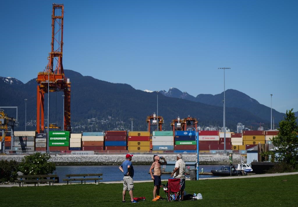 FILE. A man drinks a beer at Crab Park in Vancouver, on Saturday, May 13, 2023. Flood and fire risks in B.C.'s interior continue as unseasonably hot weather gripped much of the province this weekend.