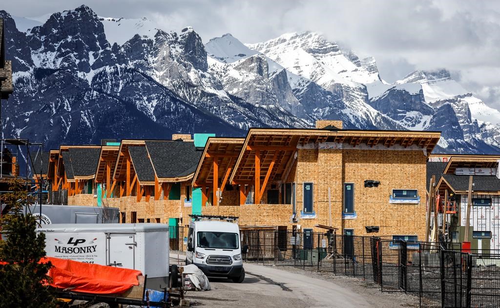 Mt. Rundle rises behind homes being constructed in Canmore, Alta., Monday, April 24, 2023.