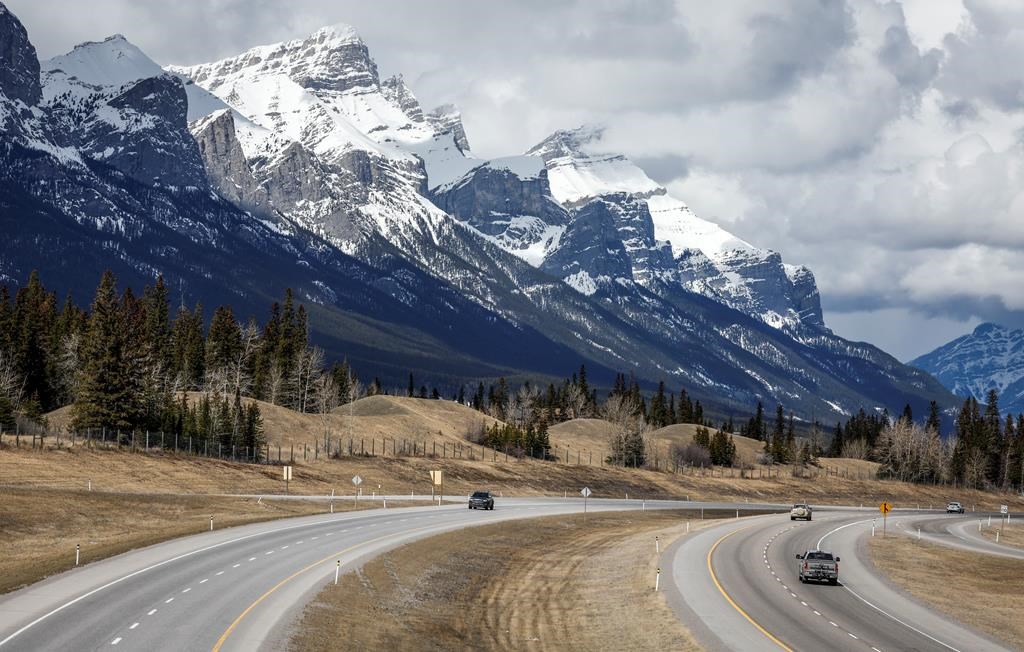 Traffic travels along the Trans Canada Highway past Mount Rundle of the Rocky Mountains near Canmore, Alta., on April 24, 2023.