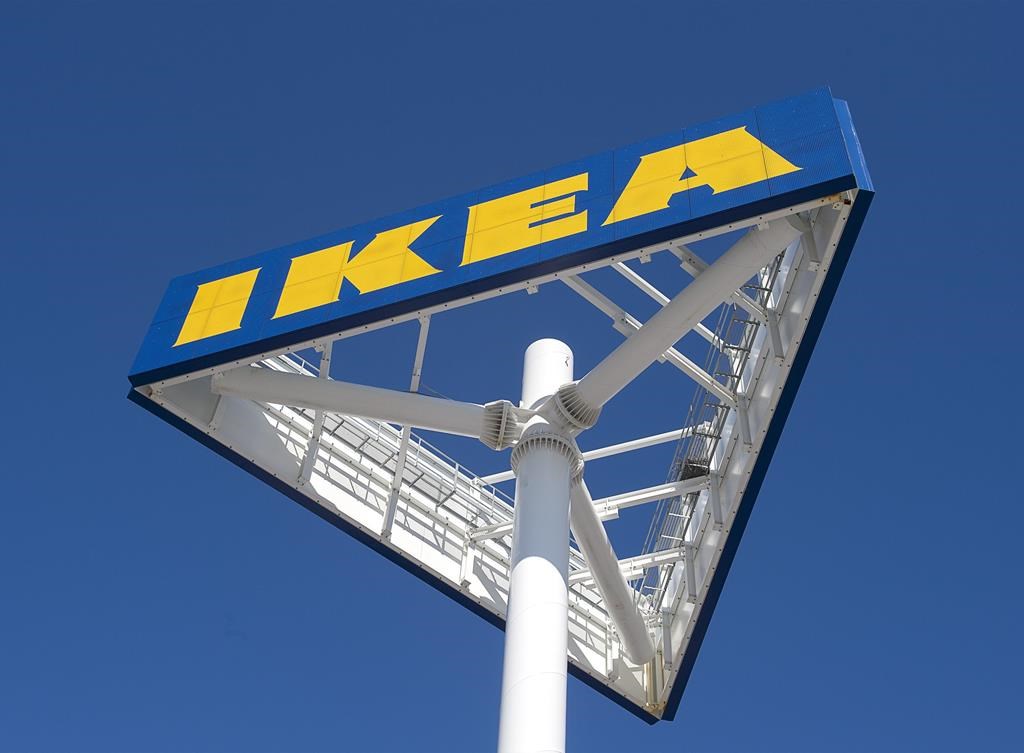 A photo of a pole with an IKEA sign on top in front of a blue sky.