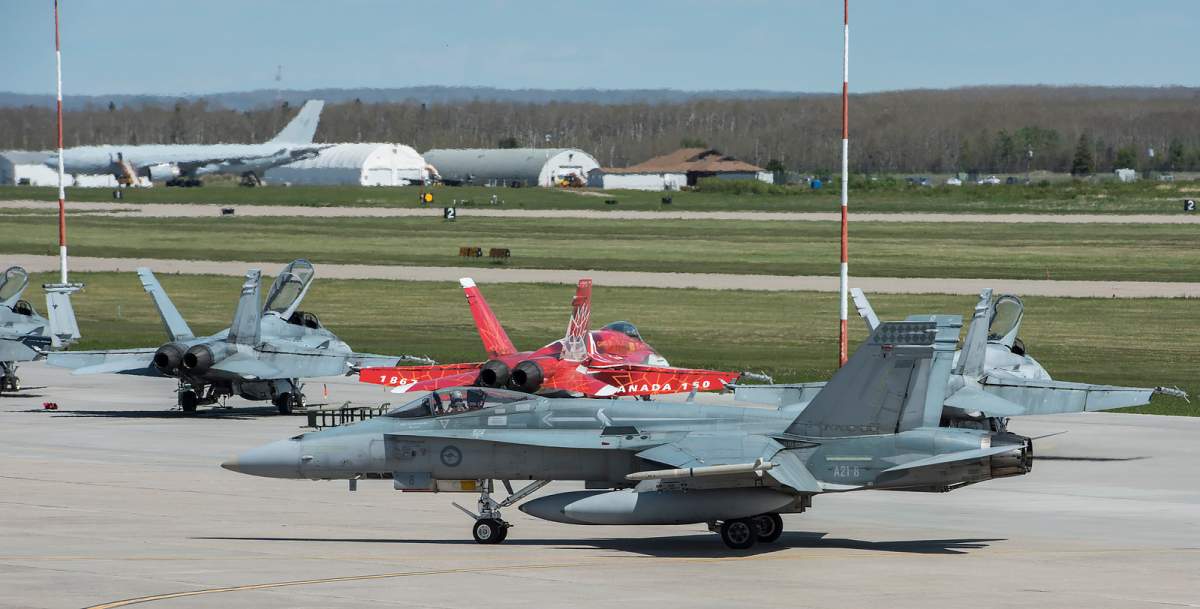 A Royal Australian Air Force F-18 Hornet taxis past Royal Canadian Air Force CF-188 Hornets on the ramp outside 3 Hangar upon its arrival for Exercise MAPLE FLAG 51 at 4 Wing, Cold Lake, Alberta on June 6, 2018.