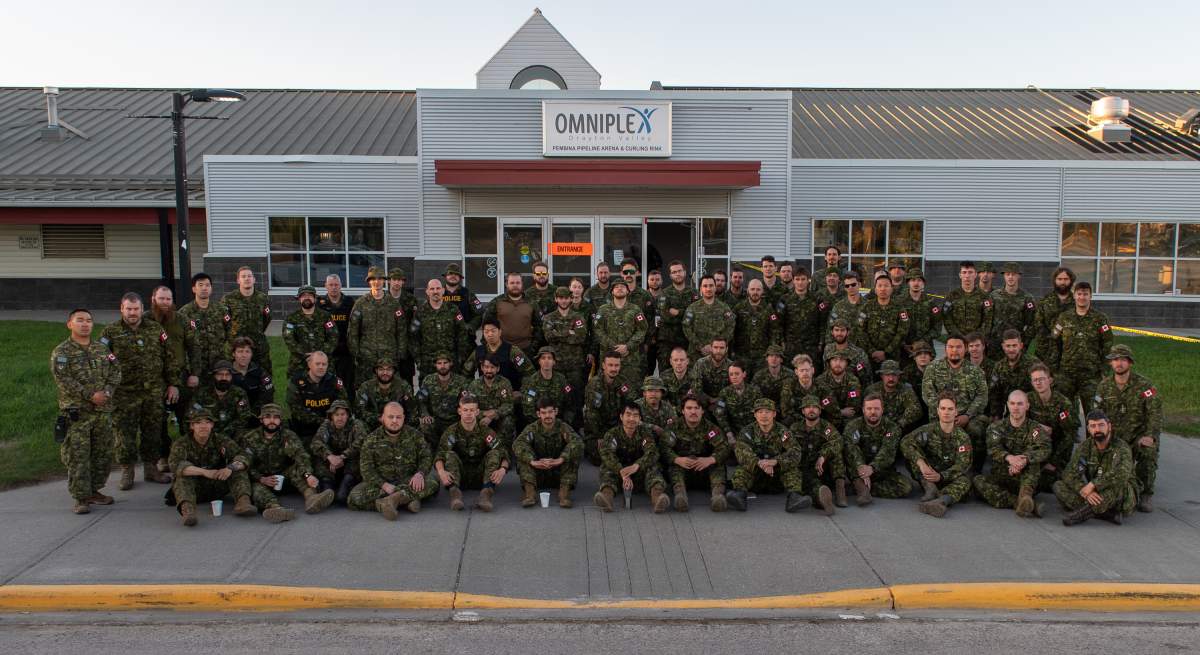 Members from CFB Edmonton 1 Combat Engineer Regiment (1 CER) pose for a group picture while fighting wildfires near Drayton Valley, Alta. on May 15, 2023.