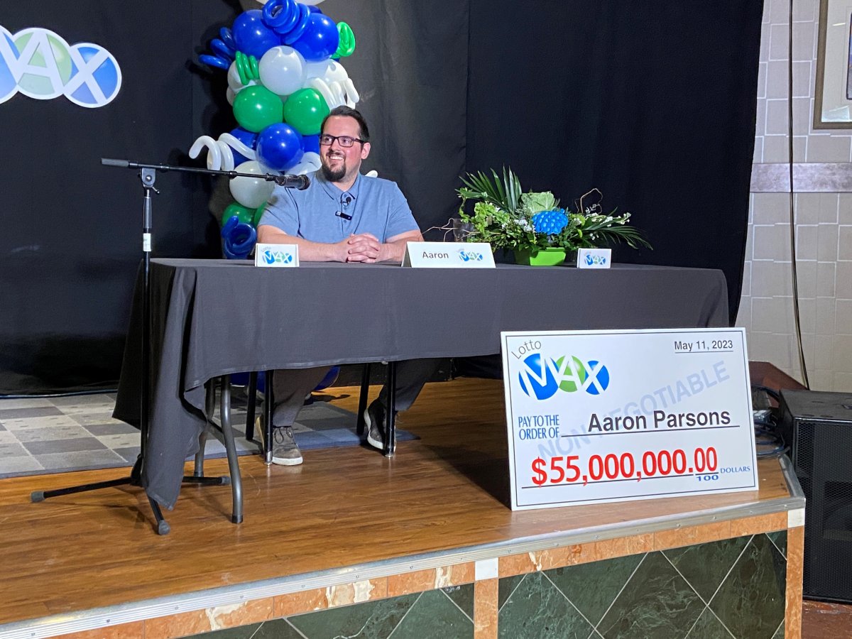 Lethbridge resident, Aaron Parsons, sitting in front of his $55 milllion lottery win.
