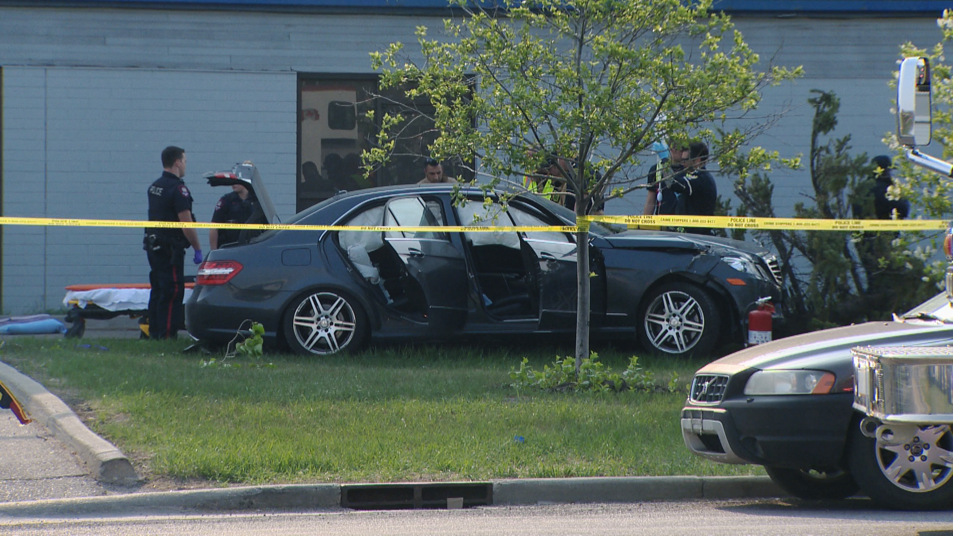 Police tape surrounds a car in a northeast Calgary business park Thursday afternoon following a fatal shooting.