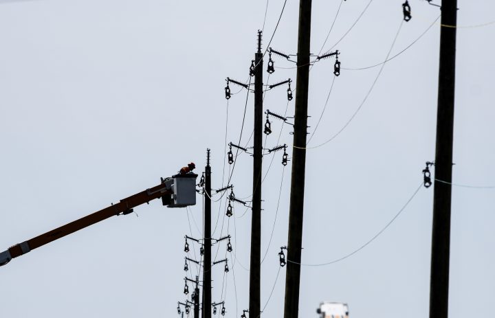 A utility worker works from a bucket lift along after a storm caused damage to the city’s power distribution network, in Ottawa, on Tuesday, May 24, 2022.