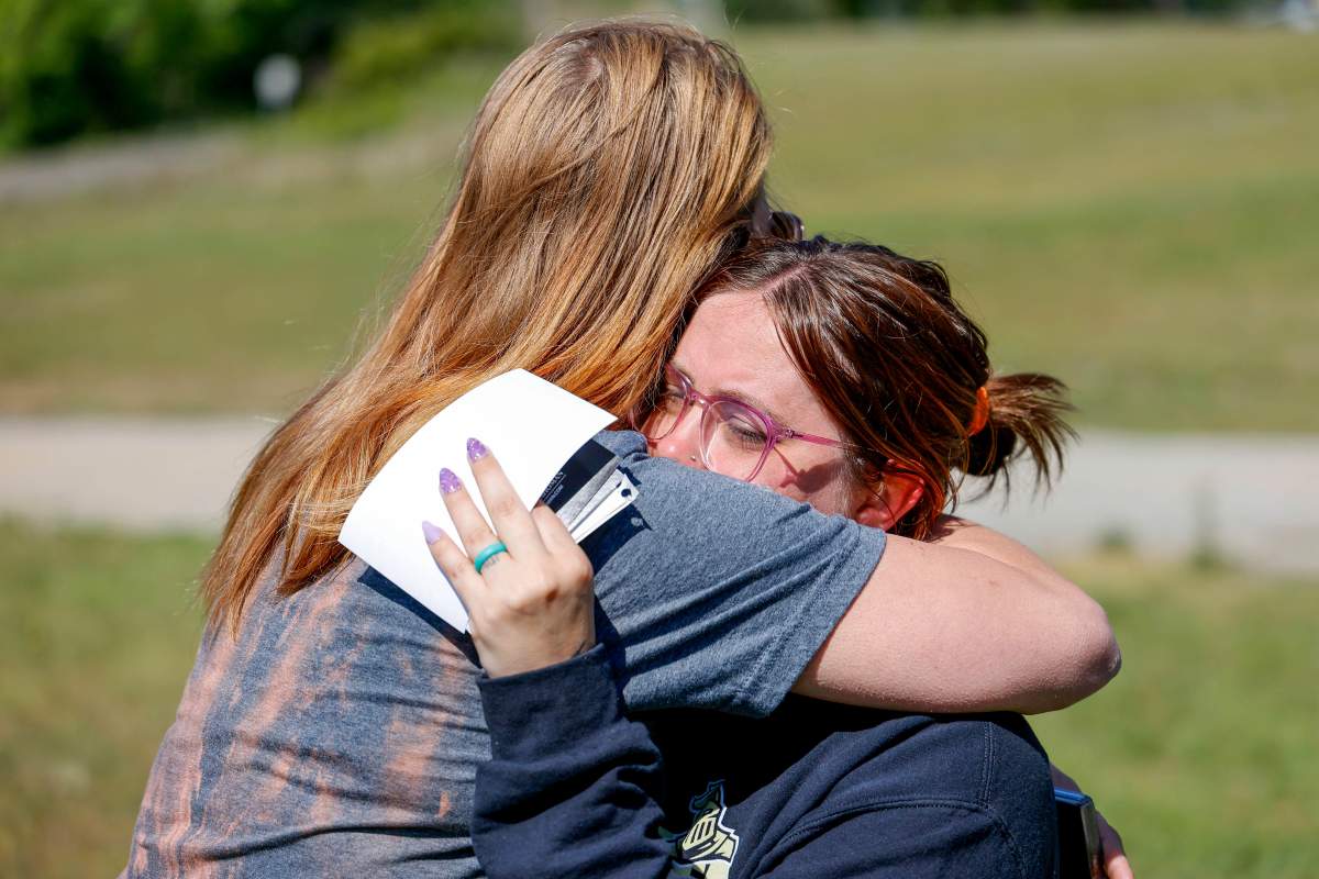 Ashleigh Webster hugs family friend Shannon Dillon at her home in Henryetta, Okla., Tuesday, May 2, 2023.